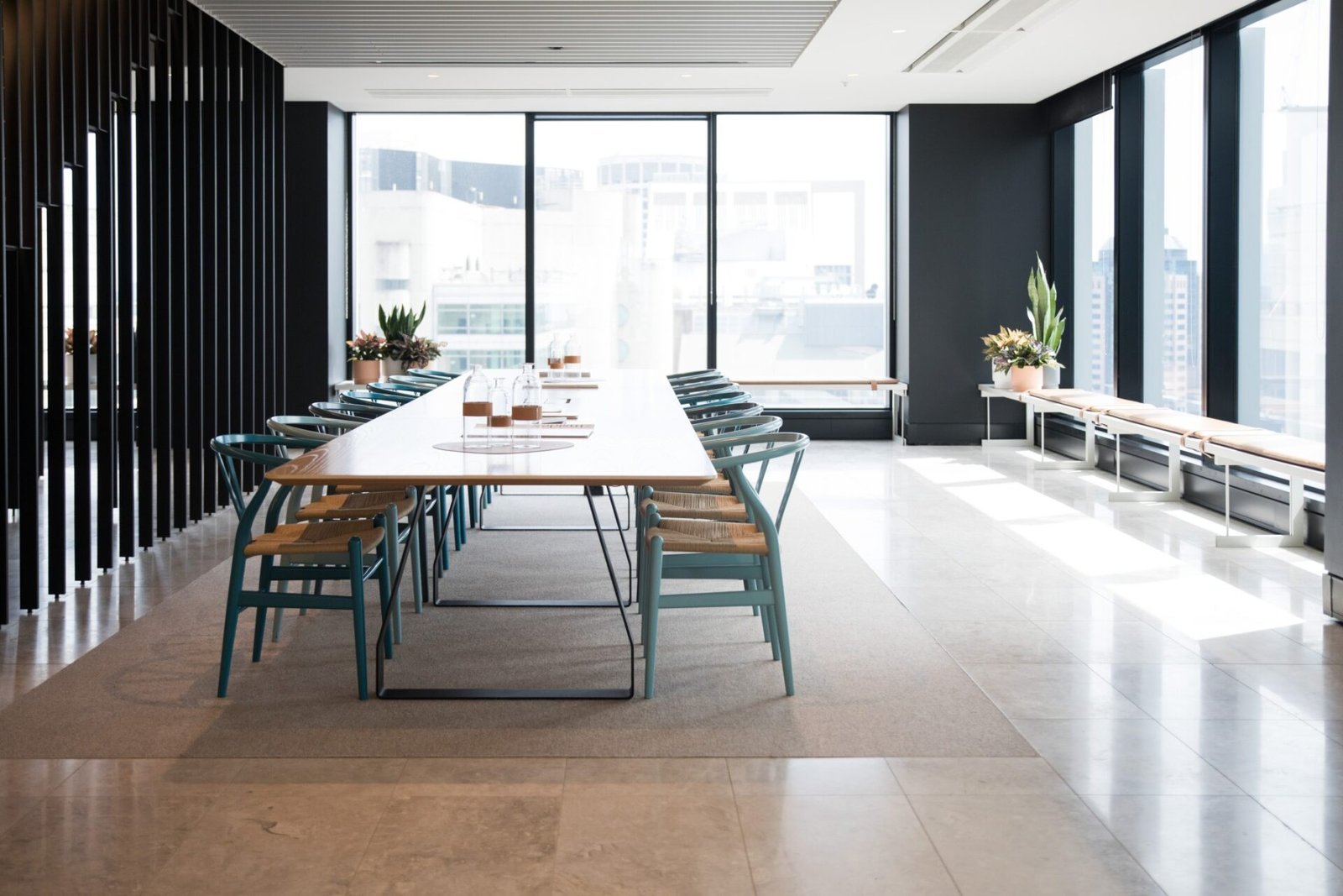 A conference room with a long table and chairs.
